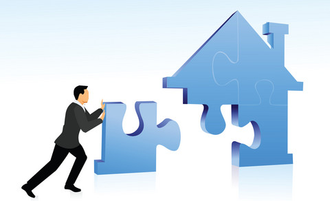 home loan Businessman arranging jigsaw puzzle pieces to build a house