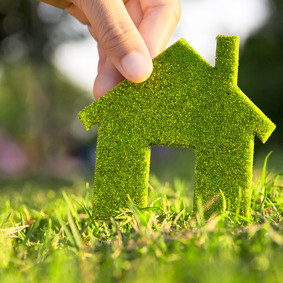 Eco house concept ,hand holding eco house icon in nature Eco house concept ,hand holding eco house icon in nature